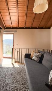a living room with a couch and a large window at Casa das Castanhas - Cinfães, Viseu in Cinfães