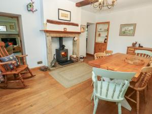 a living room with a wooden table and a fireplace at Barley Cote Farm in Keighley