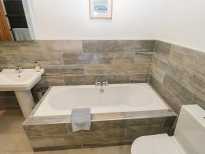 a bathroom with a bath tub and a sink at Barley Cote Farm in Keighley +44 photos