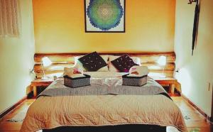 a bedroom with a bed with two lamps on it at Pousada Bocaina in São Pedro da Serra