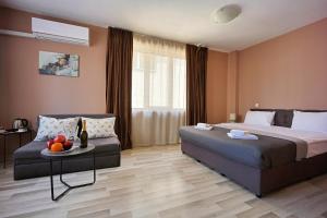 a hotel room with a bed and a table with fruit on it at Hotel Leda in Sofia +84 photos