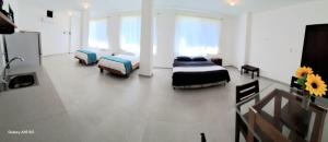 a bedroom with two beds and a tv in it at Barrio Central in Puerto Ayora +2 photos