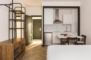 a kitchen and dining room with a table and chairs at Honest Granada Apartments in Granada