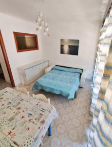 a room with a bed and a table and chairs at Giglio Gold in Giglio Porto +8 photos