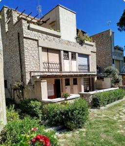 an old stone building with flowers in front of it at Giglio Gold in Giglio Porto