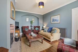 a living room with a couch and a table at Lantern House - North East Escapes in Belford +27 photos