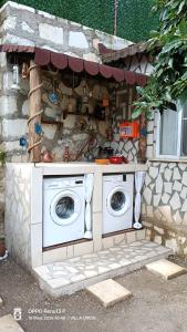 a outdoor kitchen with two washing machines in a house at Finike Apart Orion in Finike