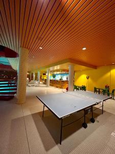 a ping pong table in the middle of a room at Leo Loft - Pool, Sauna & Free Parking in San Bernardino