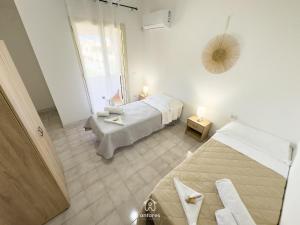 a bedroom with two beds and a window at Residenza Centrale in Villasimius