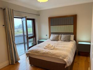 a bedroom with a bed with two teddy bears on it at Birchall Lodge in Galway
