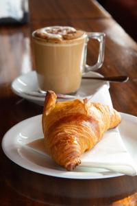 a croissant and a cup of coffee on a table at Hotel Galera in San Antonio +26 photos