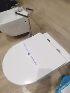 a white toilet sitting next to a sink at Nela in Carini +18 photos