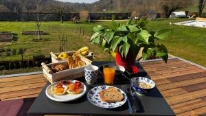 a tray of breakfast food on a table at A l'ombre des vignes, chambres d'hôtes 3 épis avec piscine in Poncin