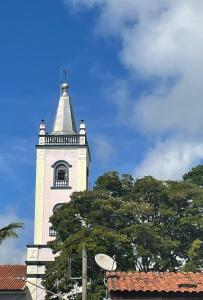 a tall white tower with a window on it at Pousada Lourenço in Nazaré Paulista +11 photos