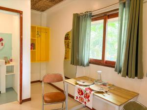 a dining room with a table and a window at Copacabana Siargao Boutique Hotel & Artcafé in General Luna