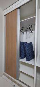 a closet with two blue pillows in it at Boulevard suíte hotel suíte 1220 in Caldas Novas +34 photos