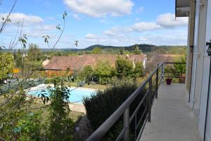 a balcony with a view of a swimming pool at La Tulipe Périgourdine in Le Buisson de Cadouin