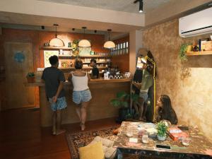 a group of people standing at a bar at Copacabana Siargao Boutique Hotel & Artcafé in General Luna