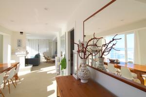 a dining room and living room with a table and chairs at Luaña Beach House in Cóbreces +29 photos