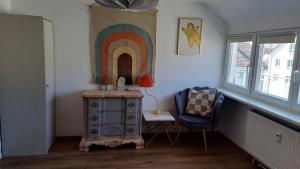 a room with a dresser and a rainbow on the wall at Blick auf den Magdalenenberg in Villingen-Schwenningen