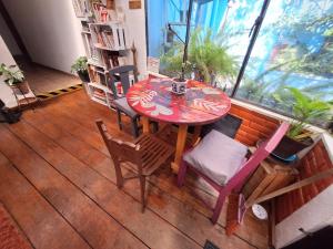 a table and chairs in a room with a window at Punto DF - Airport in Mexico City