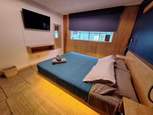 a bedroom with a bed and a television in it at Punto DF - Airport in Mexico City +31 photos