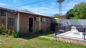a brick house with a gate in the yard at Departamento Rincon de Paz in Colón