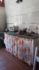 a kitchen counter with a sink and a microwave at Departamento Rincon de Paz in Colón +3 photos