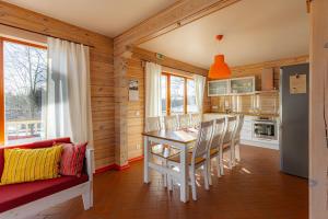 a kitchen and dining room with a table and chairs at Vasekoja Holiday Center in Vahtseliina