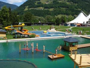 a water park with two slides and people in the water at Appartements Veronika in Silbertal