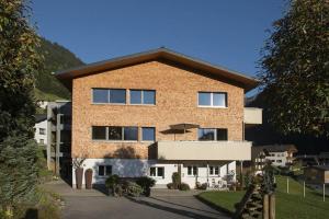 a large brick building with a roof at Appartements Veronika in Silbertal