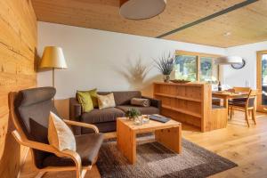 a living room with a couch and a table at Appartements Veronika in Silbertal