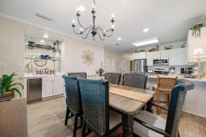 a dining room and kitchen with a table and chairs at Marlin Key 1B in Orange Beach