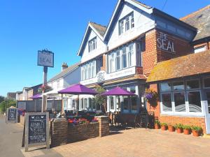 a building with purple umbrellas on a street at The Seal in Selsey
