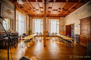 a large room with a long table and chairs at Gite Logis des Fontaines in Raon-lʼÉtape +22 photos