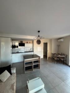 a living room and kitchen with a couch and a table at Appartement 2 pièces in Fréjus