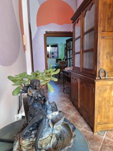 a statue of a woman sitting on a rock next to a plant at Casa Madre Amada in Candelaria +13 photos
