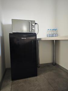 a microwave sitting on top of a table with a refrigerator at Alda in Pyrzowice