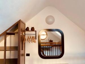 a mirror on a wall in a room at La mansardina del mulino in Lodi
