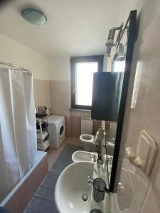 a bathroom with a sink and two toilets at La mansardina del mulino in Lodi +30 photos