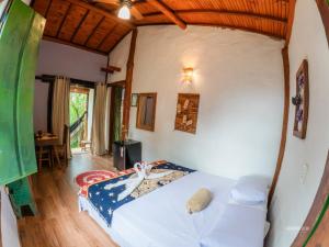 a bedroom with a bed in a room at Pousada Villa Cachoeira in Carrancas