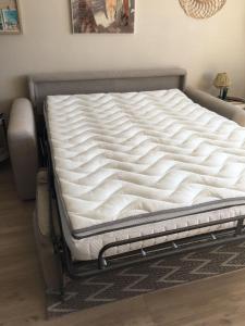 a mattress on a bed frame in a room at Studio Bénodet vue mer in Bénodet