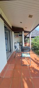 a patio with two chairs and a table on a porch at Kaz l'Oranger in Saint Esprit