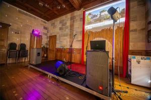 a room with a stage with a laptop on it at Gite Logis des Fontaines in Raon-lʼÉtape