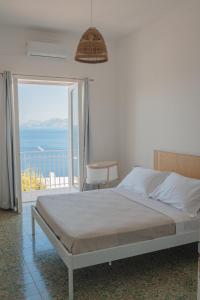 a bedroom with a bed and a view of the ocean at Casacasa Praiano in Praiano