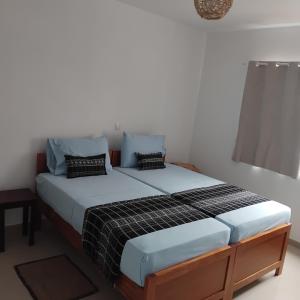 a bedroom with two beds in a room at Artimar- B&Breakfast in Ponta do Sol