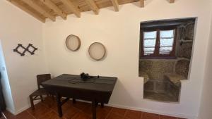 a room with a table and two mirrors on the wall at Casa da Pipela in Santo André
