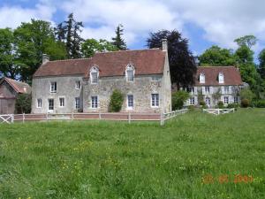 an old stone house in a field of grass at Manoir de Pincelu in La Courbe