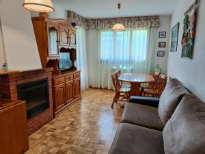 a living room with a couch and a table at Apartamento Maladeta in Torla-Ordesa