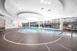 a large swimming pool in a large building at Luxury Cityscape Condo in Toronto